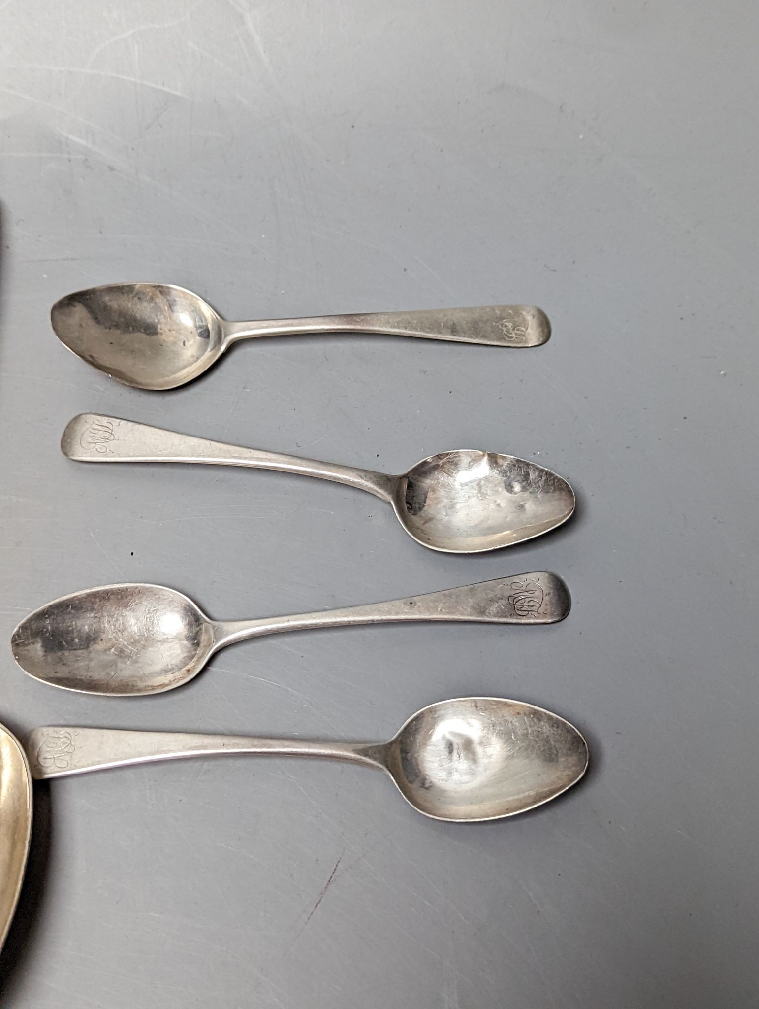 A small quantity of assorted mainly 19th century silver flatware including a pair of George III Old English pattern table spoons, Smith & Hayter, London, 1794 and a silver butter knife, 15oz